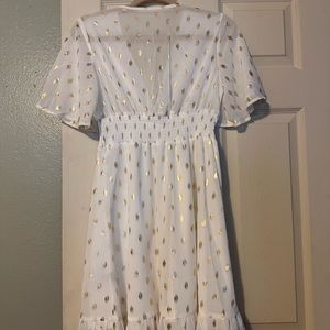White polka dot nice dress, ruffle hem, deep V neck, half sleeve.